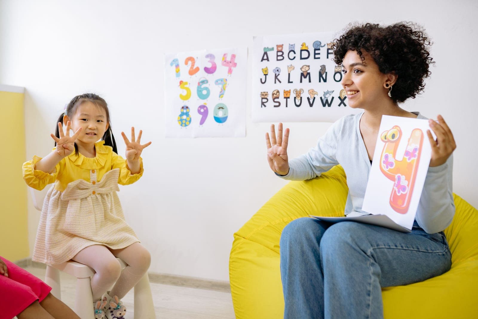 An early childhood educator leading a counting activity